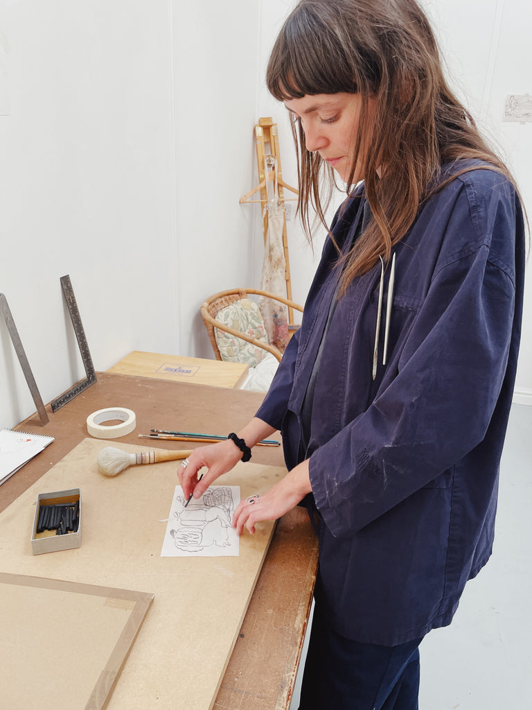 Iluustrator, repair, artist in studio, wearing studio kimono, navy jacket