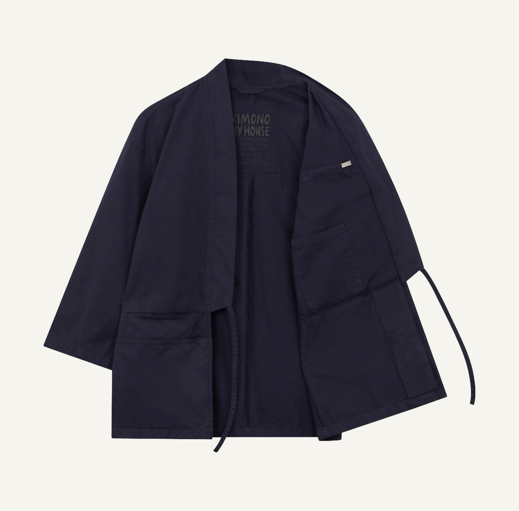 A medium weight organic cotton studio kimono, in the colour deep sea navy showing the internal phone holder and the removable magnet